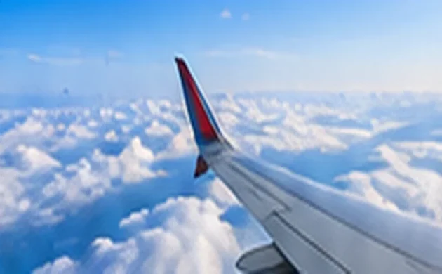 Airplane wing above clouds while comparing flexible travel dates
